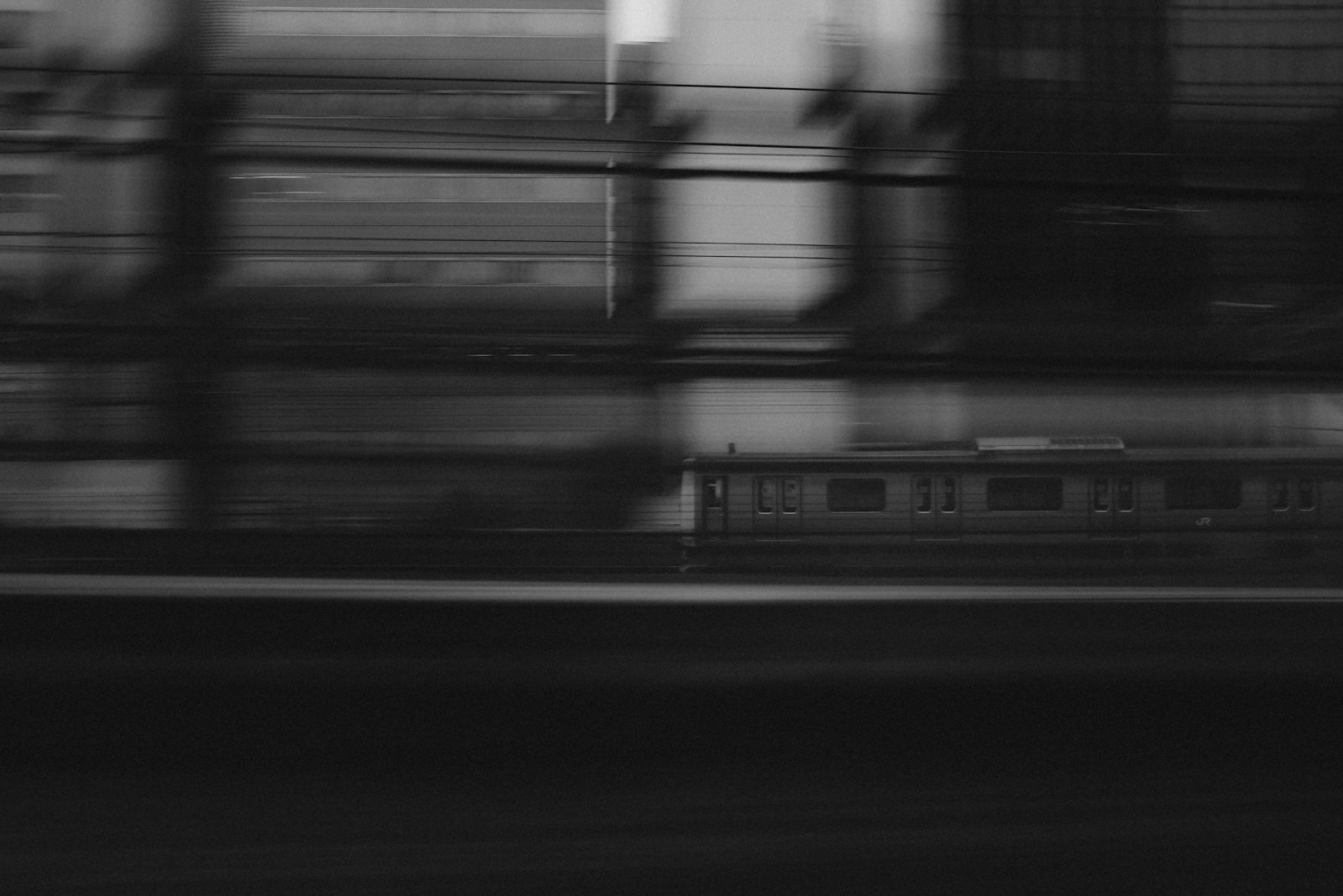 Commuter train in motion blur passing through a city